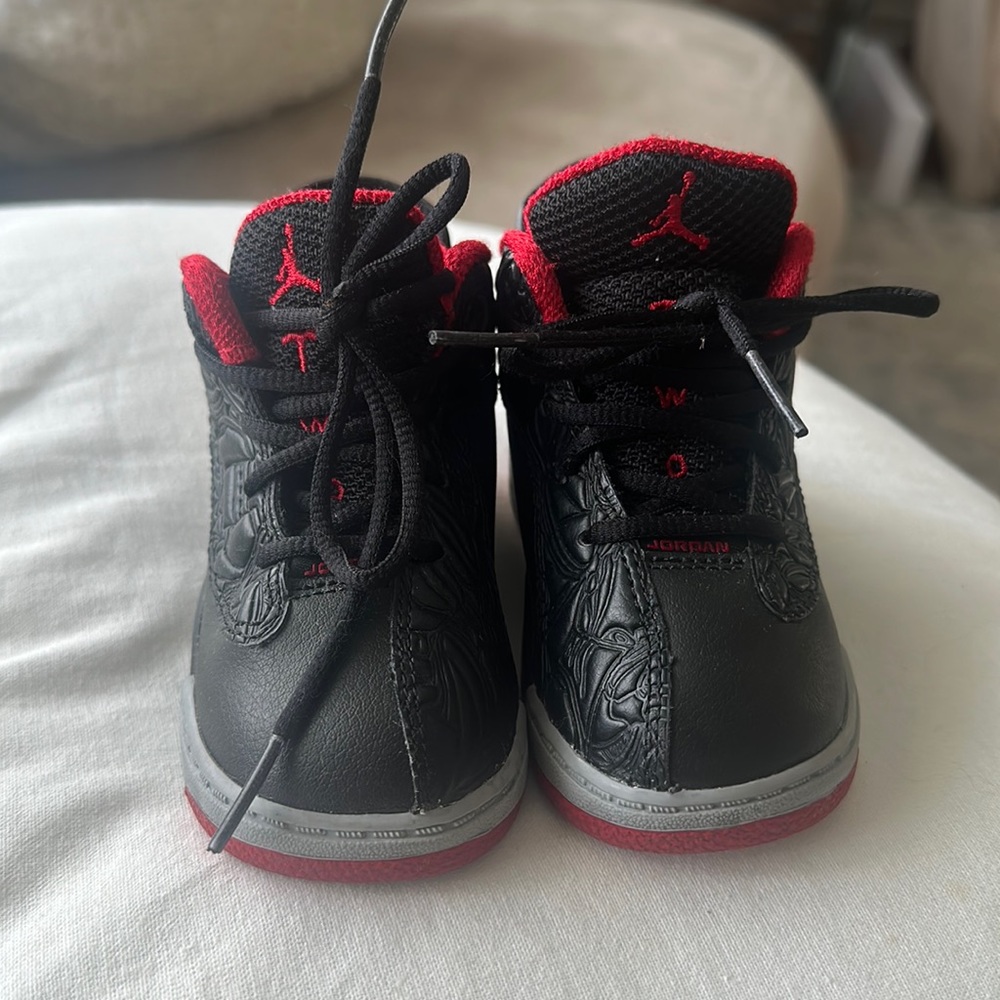 Authentic. Black, grey, red toddler Jordan’s.